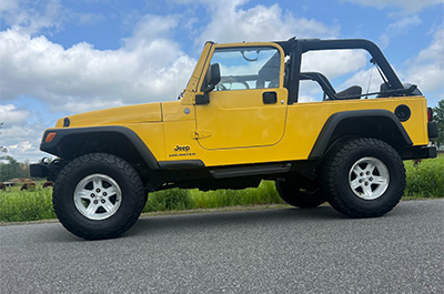 Yellow Jeep Wrangler from the side